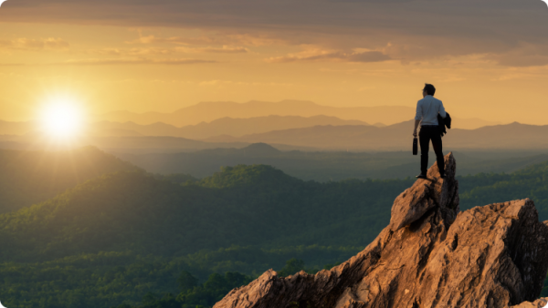 Person on mountaintop, admiring the sunset view